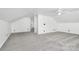 Open bonus room with neutral walls, plush carpet, and vaulted ceiling at 12300 Caldwell Rd, Charlotte, NC 28213