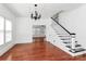 Bright dining room with traditional chandelier, staircase, and view into the adjacent living room at 12300 Caldwell Rd, Charlotte, NC 28213
