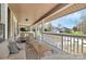 Relax on this cozy front porch complete with stylish furniture, perfect for enjoying neighborhood views at 12300 Caldwell Rd, Charlotte, NC 28213