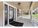 Covered front porch featuring a welcoming entrance with black door and ample space for decorative elements at 12300 Caldwell Rd, Charlotte, NC 28213