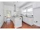 Bright kitchen features granite counters, white cabinets, stainless appliances, and hardwood floors at 12300 Caldwell Rd, Charlotte, NC 28213