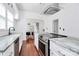 Bright kitchen features granite counters, white cabinets, stainless appliances, and hardwood floors at 12300 Caldwell Rd, Charlotte, NC 28213