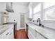 Bright kitchen features white cabinets and walls, stainless appliances, and hardwood floors at 12300 Caldwell Rd, Charlotte, NC 28213