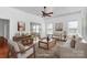 Bright, staged living room with hardwood floors, neutral furniture, and ample natural light at 12300 Caldwell Rd, Charlotte, NC 28213