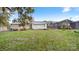 Backyard featuring grass, neighboring homes, and an outbuilding at 408 E Washington Ave, Bessemer City, NC 28016