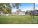 View of backyard featuring grass, neighboring homes, and an outbuilding at 408 E Washington Ave, Bessemer City, NC 28016
