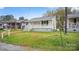 An exterior view showing the quaint home and green surroundings at 408 E Washington Ave, Bessemer City, NC 28016