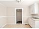 Modest kitchen with neutral walls, featuring classic white cabinets and a double basin sink at 408 E Washington Ave, Bessemer City, NC 28016