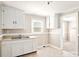 Bright kitchen featuring a double stainless steel sink, white cabinets and a window at 408 E Washington Ave, Bessemer City, NC 28016