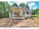 New construction backyard with pergola, wooden stairs, and mulch landscaping under blue sky at 4271 Candlewood Dr, Sherrills Ford, NC 28673