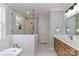 Bright bathroom featuring a soaking tub, tiled shower, and vanity with modern fixtures and white marble tiling at 4271 Candlewood Dr, Sherrills Ford, NC 28673