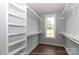 Walk-in closet with custom built-in shelves, hardwood floors, and a window allowing for natural light at 4271 Candlewood Dr, Sherrills Ford, NC 28673