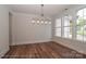 Dining room with hardwood floors, ample natural light from the large windows, and a modern chandelier at 4271 Candlewood Dr, Sherrills Ford, NC 28673