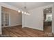 Open dining room with hardwood floors, modern chandelier, and views into the kitchen and front room at 4271 Candlewood Dr, Sherrills Ford, NC 28673