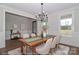 Dining room with wainscoting, modern chandelier, wood floors, and a table with seating for six at 4271 Candlewood Dr, Sherrills Ford, NC 28673