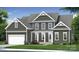 Charming two-story home featuring a covered porch, attached garage, and a beautifully landscaped front yard at 4271 Candlewood Dr, Sherrills Ford, NC 28673