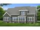 Rear view of a two-story home with large windows, green siding, a roof, and a well-manicured lawn at 4271 Candlewood Dr, Sherrills Ford, NC 28673
