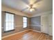 Gray bedroom with two windows and a ceiling fan providing plenty of natural light at 4706 Calico Ct, Charlotte, NC 28212