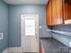 The mudroom includes a gray countertop, wooden cabinets, and a glass door at 4706 Calico Ct, Charlotte, NC 28212