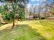 Spacious backyard with mature trees and a stone patio at 501 W Maryland Ave, Bessemer City, NC 28016