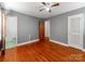 Bedroom with hardwood floors, gray walls, and ensuite bathroom at 7101 Ridgebrook Dr, Charlotte, NC 28210