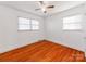 Bright bedroom featuring hardwood floors and ceiling fan at 7101 Ridgebrook Dr, Charlotte, NC 28210