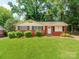 Charming single-story brick home featuring a well-maintained lawn and mature trees at 7101 Ridgebrook Dr, Charlotte, NC 28210