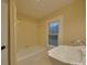 Bathroom with tub, sink, and window at 126 E Division Ave, Salisbury, NC 28144
