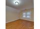 Bright bedroom with hardwood floors and two windows at 126 E Division Ave, Salisbury, NC 28144