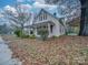 Quaint house with covered porch and autumn leaves at 126 E Division Ave, Salisbury, NC 28144
