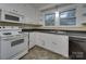White kitchen with appliances, double sink, and tile floor at 126 E Division Ave, Salisbury, NC 28144