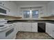 White kitchen with appliances, double sink, and tile floor at 126 E Division Ave, Salisbury, NC 28144