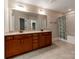 Bathroom featuring double sinks, a large mirror, and a shower-tub combo with curtain at 14700 Old Vermillion Dr, Huntersville, NC 28078