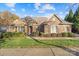 Charming single-story brick home featuring manicured landscaping and an inviting entrance, complete with shuttered windows at 14700 Old Vermillion Dr, Huntersville, NC 28078