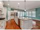 Spacious eat-in kitchen with an island, stainless steel appliances, and lots of windows for natural light at 14700 Old Vermillion Dr, Huntersville, NC 28078
