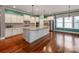 Elegant kitchen with white cabinets, granite countertops, stainless steel appliances, and a large center island at 14700 Old Vermillion Dr, Huntersville, NC 28078