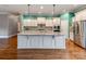 Bright kitchen features white cabinets, granite countertops, stainless steel appliances, and a large island at 14700 Old Vermillion Dr, Huntersville, NC 28078