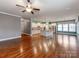Open-concept living space with hardwood floors seamlessly connecting to a modern kitchen with stylish island at 14700 Old Vermillion Dr, Huntersville, NC 28078
