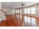 Open-concept living room featuring hardwood flooring, recessed lighting, ceiling fans, and multiple windows at 14700 Old Vermillion Dr, Huntersville, NC 28078