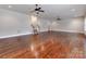 Open-concept living room featuring hardwood flooring, recessed lighting, ceiling fans, and stairway at 14700 Old Vermillion Dr, Huntersville, NC 28078