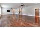Open-concept living room featuring hardwood flooring, recessed lighting, ceiling fans, and stairway at 14700 Old Vermillion Dr, Huntersville, NC 28078