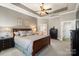 Spacious bedroom features tray ceilings, neutral colors, large windows, and an ensuite bathroom at 14700 Old Vermillion Dr, Huntersville, NC 28078