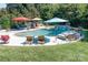 Beautiful outdoor pool area with lounge chairs, umbrellas, and lush greenery, perfect for relaxation at 14700 Old Vermillion Dr, Huntersville, NC 28078