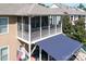 Elevated screened-in porch with white railings and blue-striped awning for outdoor relaxation and shade at 14700 Old Vermillion Dr, Huntersville, NC 28078