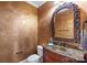 Small bathroom with ornate mirror and brown walls at 5752 Natoma Rd, Lake Wylie, SC 29710