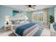 Calming blue bedroom showcasing coastal decor, a large bed, and bright natural light at 5752 Natoma Rd, Lake Wylie, SC 29710