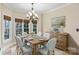 Charming dining room featuring natural light, a chandelier, and a rustic wooden table at 5752 Natoma Rd, Lake Wylie, SC 29710