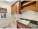 Convenient laundry room with built-in cabinets, a sink, and a window for natural light at 5752 Natoma Rd, Lake Wylie, SC 29710