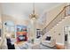 Bright living room with fireplace, staircase, large windows, and contemporary furnishings at 5752 Natoma Rd, Lake Wylie, SC 29710