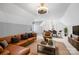 Cozy living room with a leather couch, neutral tones, and adjacent dining area at 5752 Natoma Rd, Lake Wylie, SC 29710